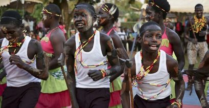 In this photo taken Tuesday, Dec. 12, 2017, former child soldiers of the Lord's Resistance Army (LRA) and community members make a traditional Acholi dance performance at a music therapy pilot program in Gulu, Uganda. A brutal rebellion by the LRA brought years of suffering to the people of northern Uganda and now that the fighting is over, a group of former child soldiers is helping some heal through music therapy. (AP Photo/Adelle Kalakouti)